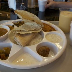 Thalimart 9 compartment round white plastic plate thali with food